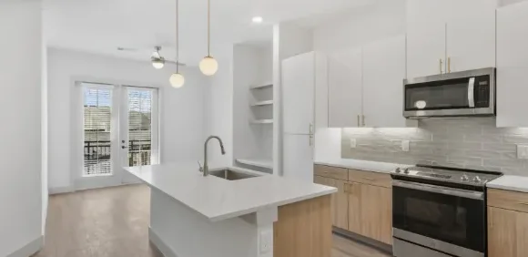 Kitchen with a white quartz island at the top pick apartment